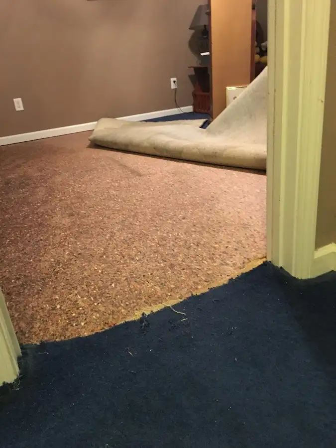 Carpet pad removal revealing water damage during Drying & Dehumidification in Tuttle